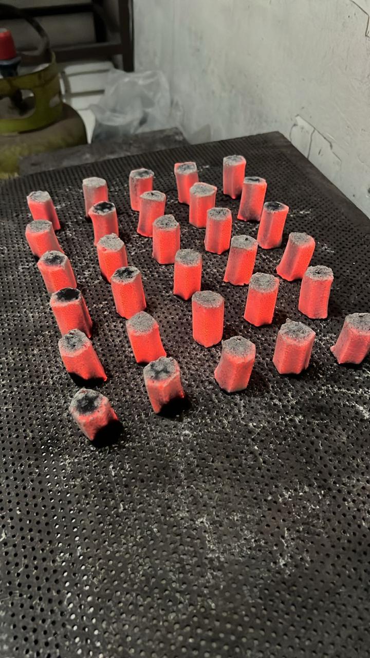 Glowing coconut charcoal briquettes